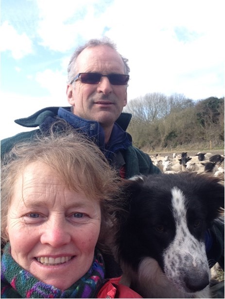 a man and a woman taking a selfie with a dog